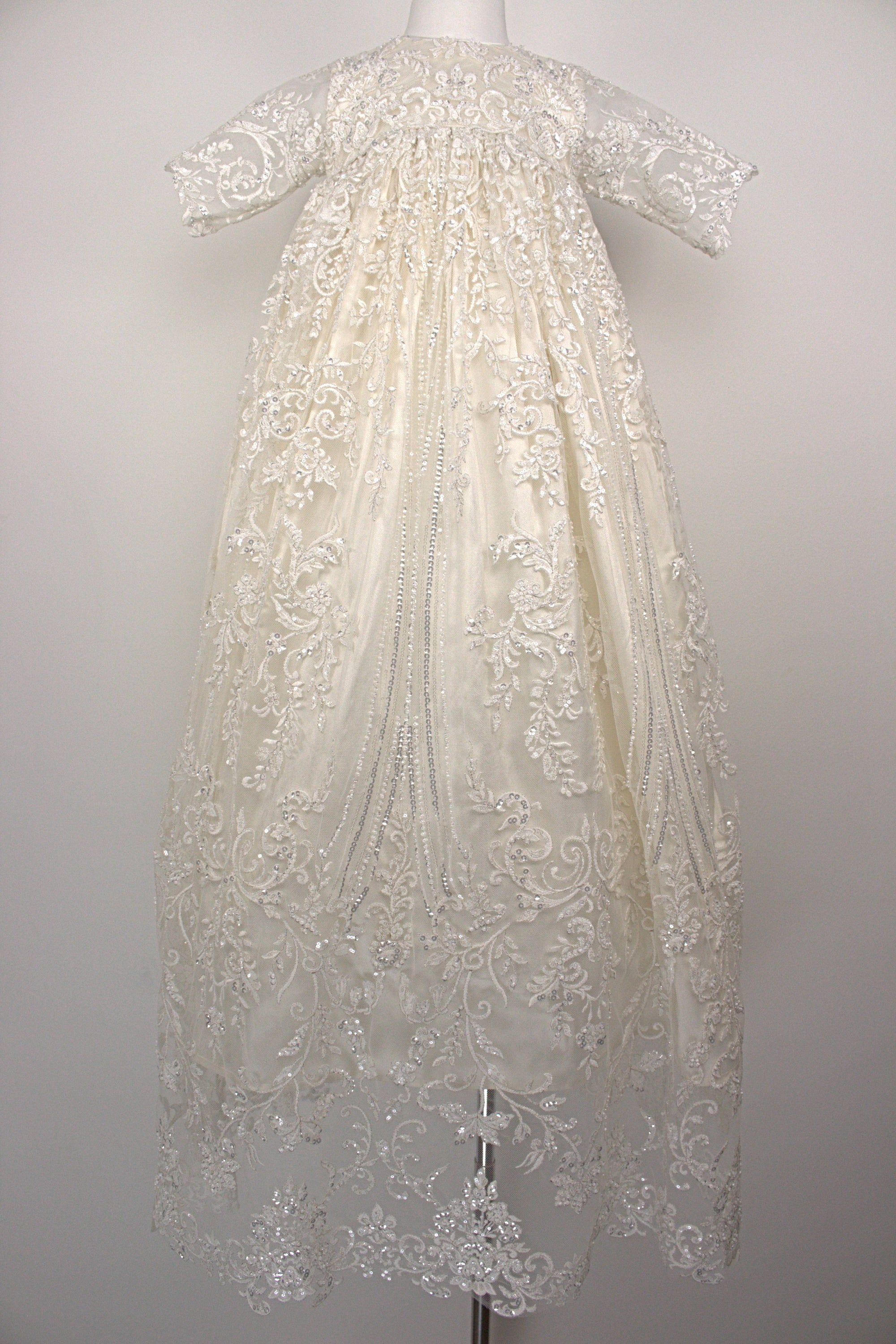 My Blessing Wholesome ivory christening gown set featuring a lace‑embroidered bodice, short sleeves, and a flowing satin skirt.