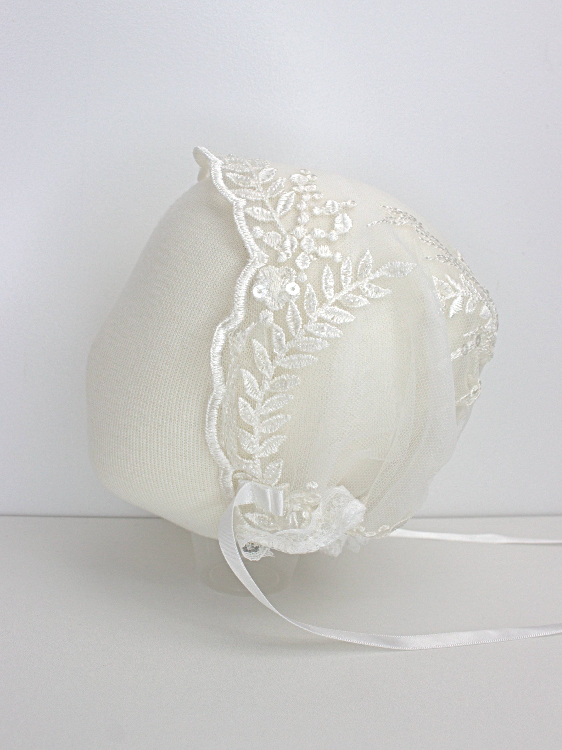 My Blessing ivory christening bonnet from the Worthy set with lace embroidery and satin ties.