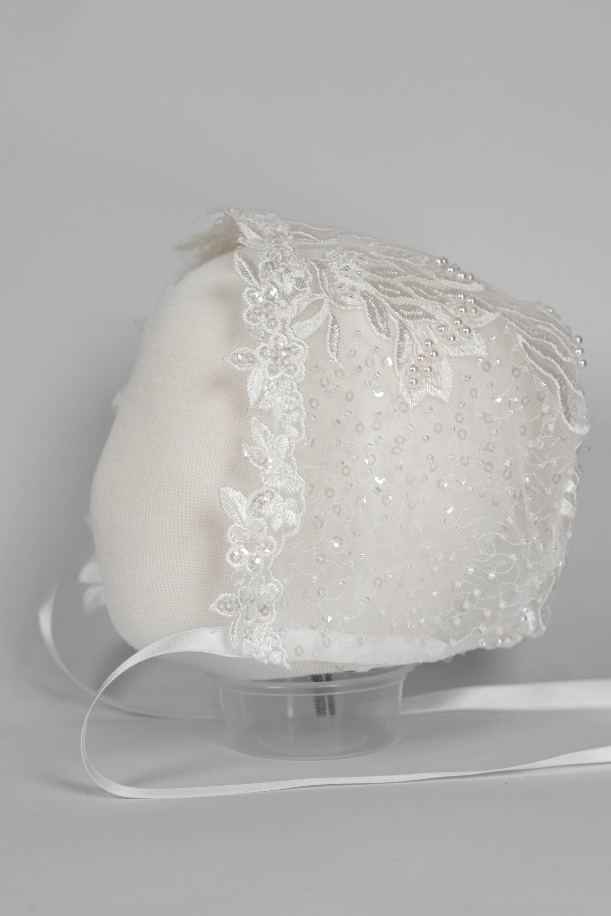 Ivory christening bonnet from the My Blessing Zillah set featuring European bridal lace with Swarovski crystals, pearls, tubed glass beads and seed beads.
