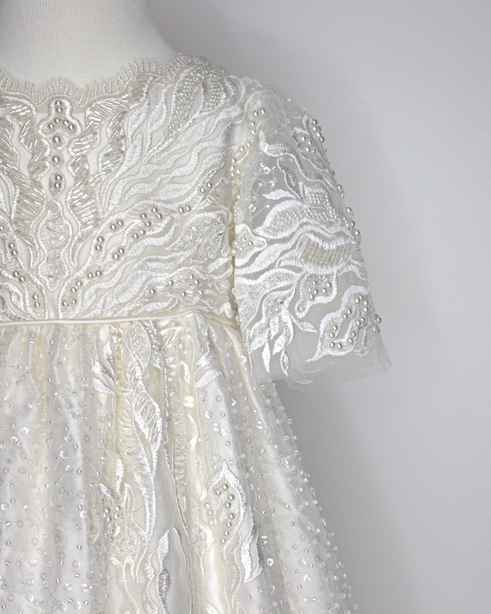 Ivory full‑length My Blessing Zillah christening gown featuring European bridal lace with intricate beadwork including Swarovski crystals, pearls, tubed glass beads and seed beads.